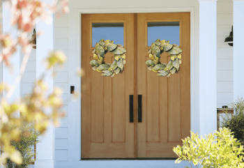 Faux leaf wreath on wooden entry door
